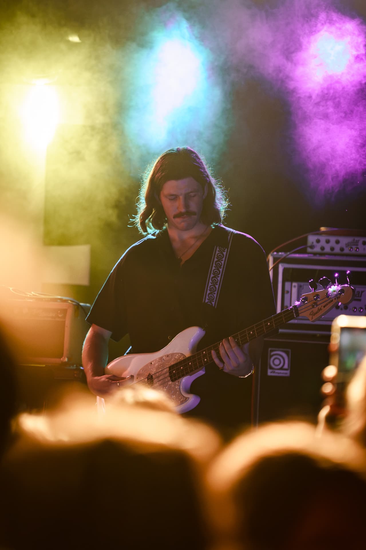 Bassist playing live through smoke and light