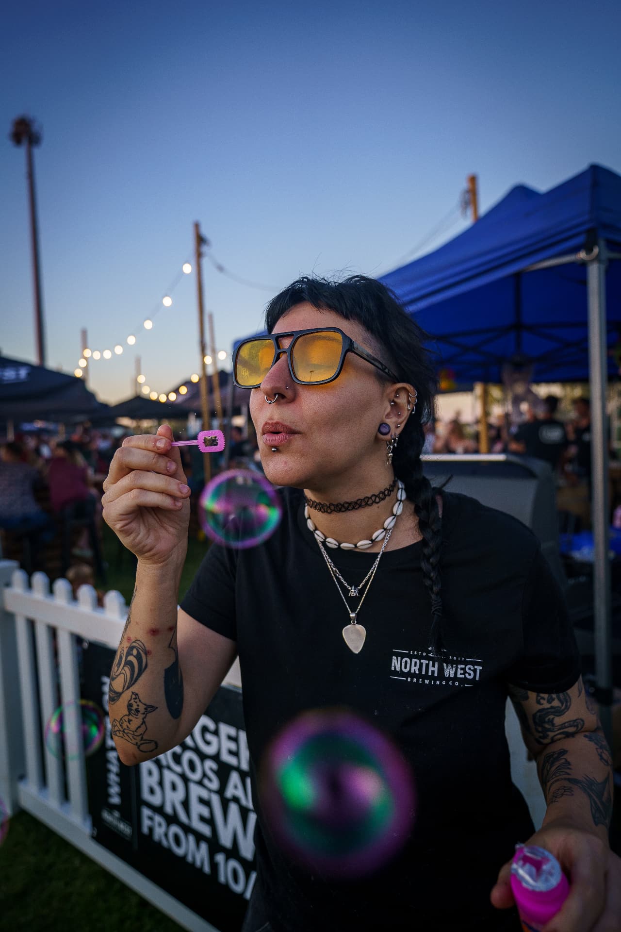 Woman blowing bubbles at an outdoor event