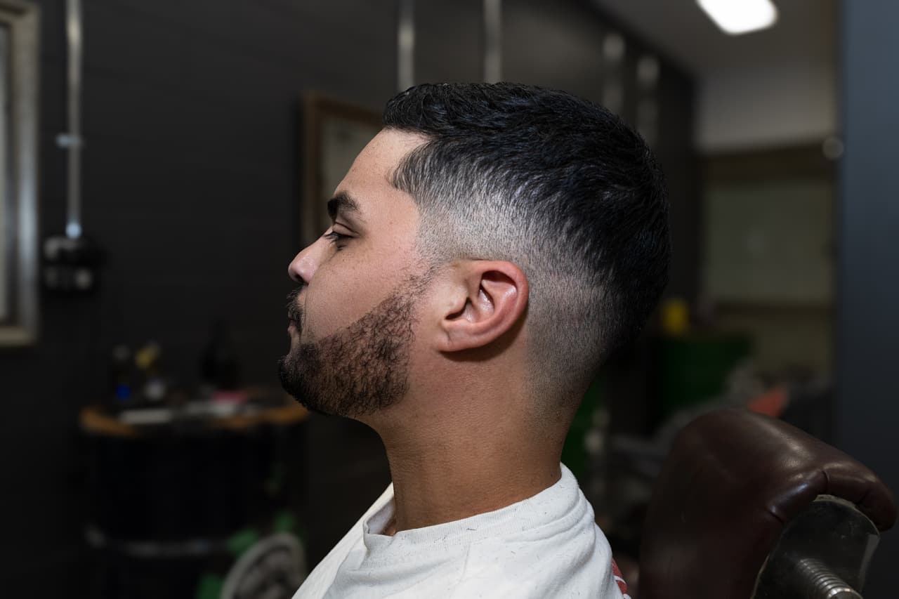 Client in profile showing a skin fade and shaped beard