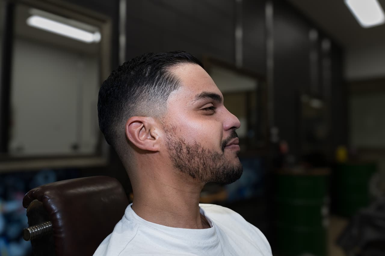 Client in three-quarter profile with a fresh fade