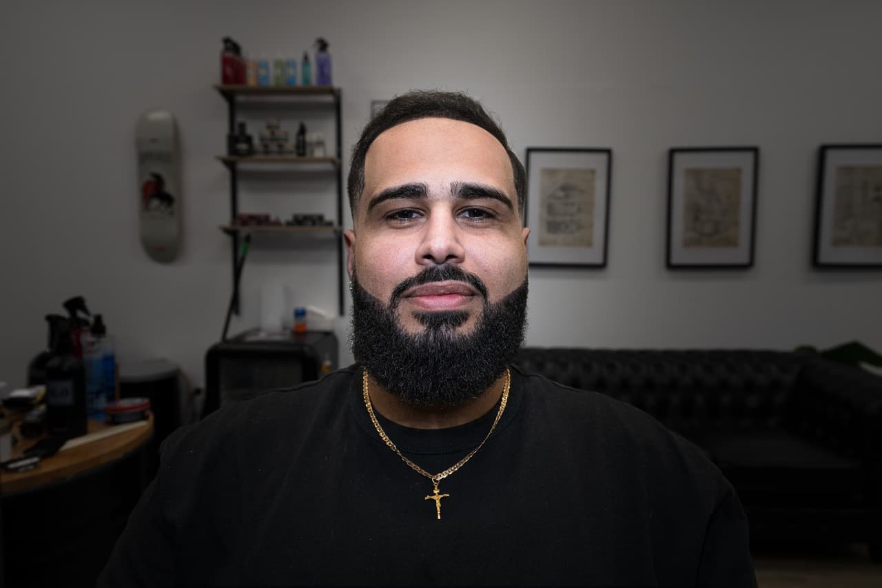 Client facing camera with a full beard and gold chain