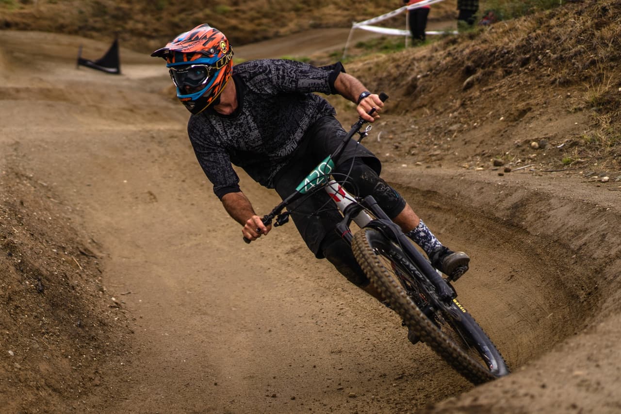 Mountain biker carving a dirt berm