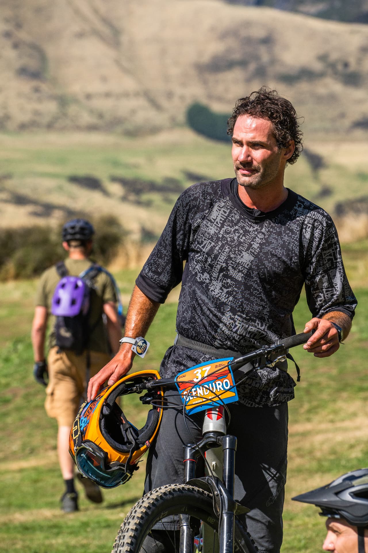 Rider walking his bike back up the hill