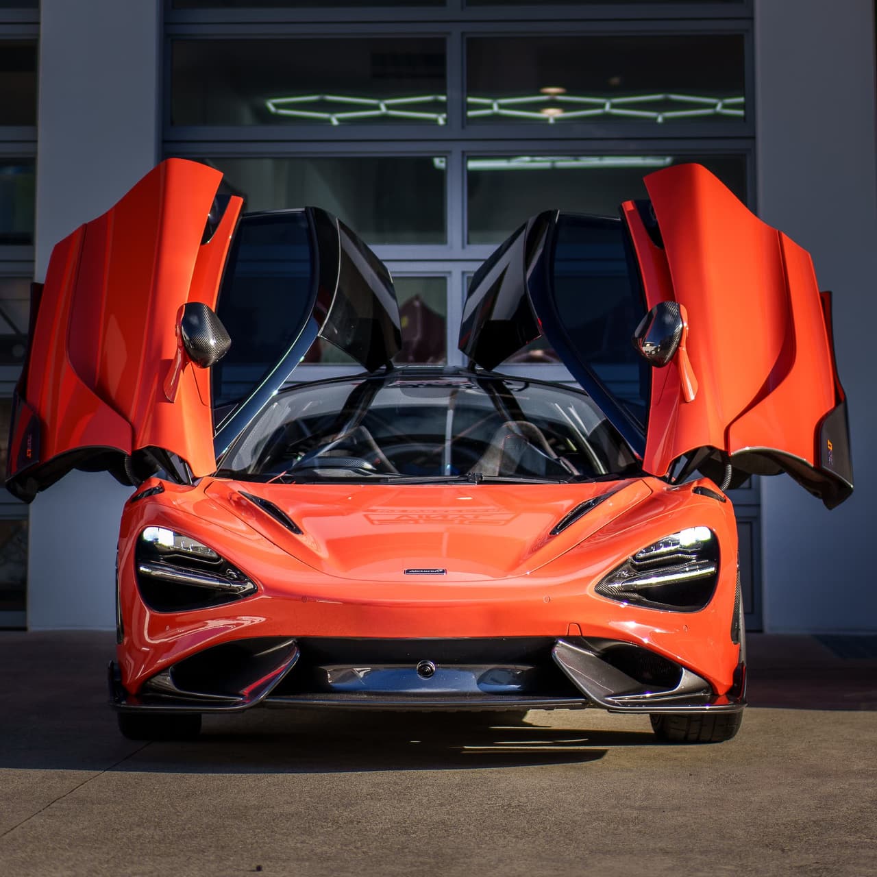 Orange McLaren 765LT with dihedral doors open